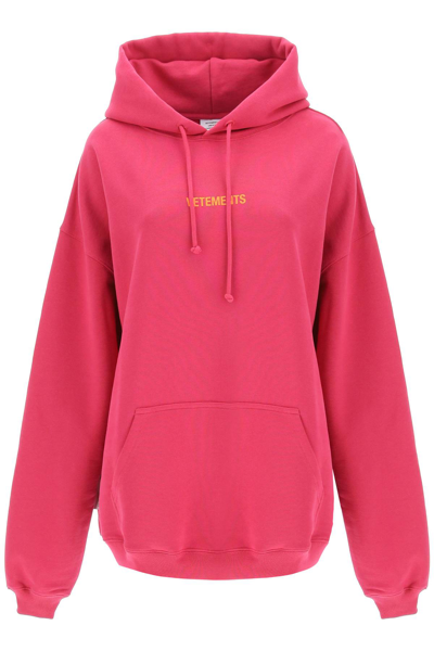Shop Vetements Logo Label Hoodie In Hot Pink Orange (fuchsia)