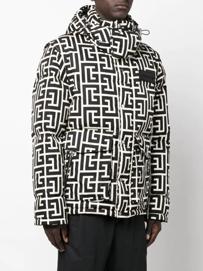 Balmain monogram-pattern padded sleeveless jacket worn by Cane