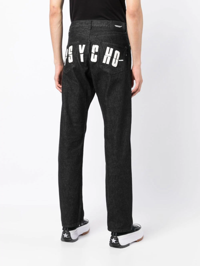 Shop Undercover X Psycho Logo-appliqué Jeans In Black