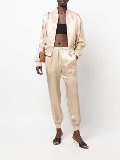 Shop Palm Angels Logo-print Satin Track Pants In Nude
