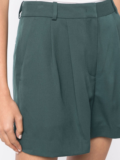 Shop Juunj Concealed-front Fastening Pleated Shorts In Green