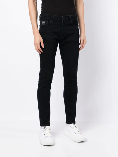 Shop Versace Jeans Couture Logo-print Skinny-fit Jeans In Black