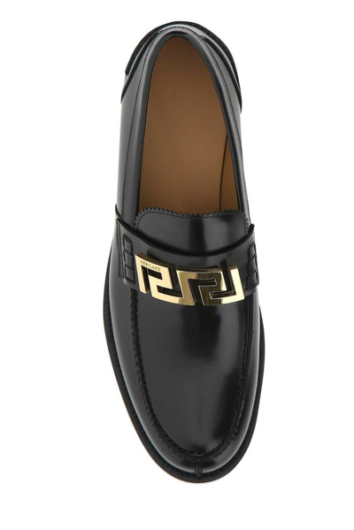 Shop Versace Greca Logo Detailed Slip-on Loafers In Nero