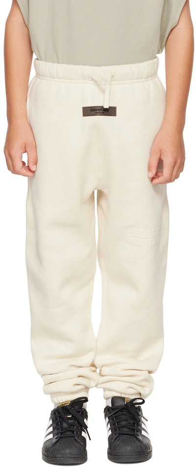 Shop Essentials Kids Off-white Logo Lounge Pants In Egg Shell