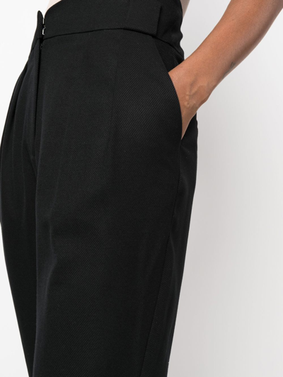 Shop Iro Pleated High-waisted Trousers In Black