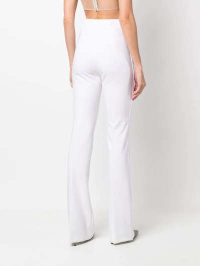 Shop Genny High-waisted Flared Trousers In Neutrals