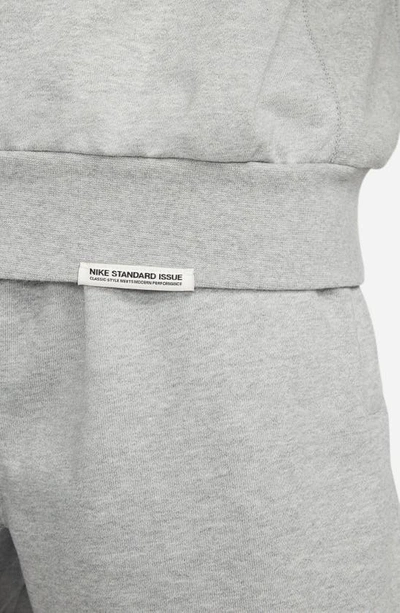 Shop Nike Dri-fit Standard Issue Crewneck Sweatshirt In Dark Grey Heather/ Pale Ivory