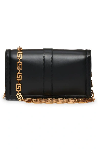 Shop Versace Greca Goddess Leather Clutch In Black- Gold