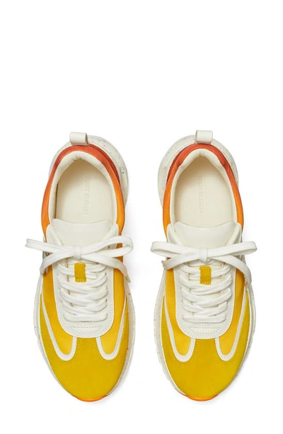Shop Tory Burch Good Luck Trainer Sneaker In Goldfinch / New Ivory