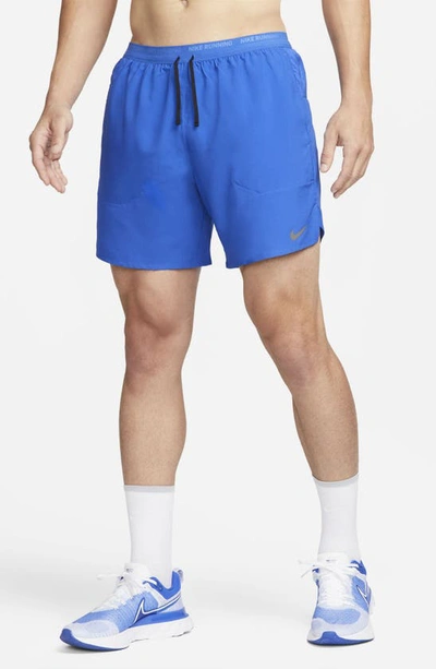 Shop Nike Dri-fit Stride 7-inch Brief-lined Running Shorts In Game Royal/ Black