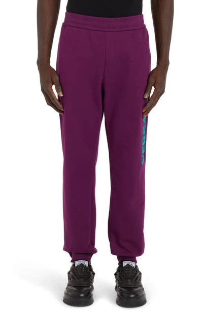 Shop Versace Varsity Patch Cotton Logo Joggers In Purple/ Turquoise