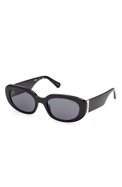 Shop Guess 54mm Oval Sunglasses In Shiny Black / Smoke