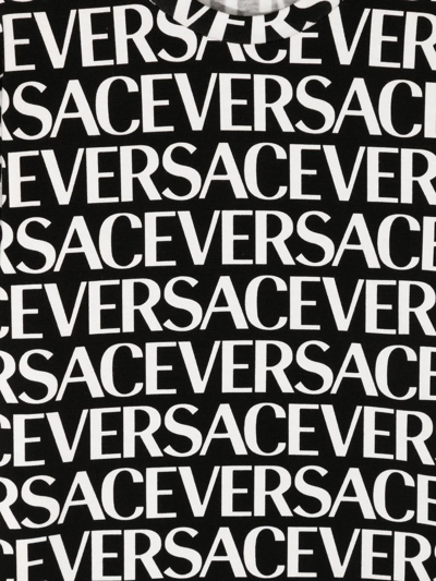 Shop Versace All-over Logo-print T-shirt In Schwarz