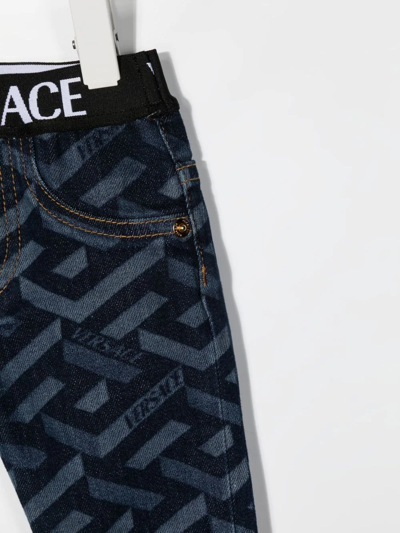 Shop Versace La Greca-print Straight-leg Jeans In Blue