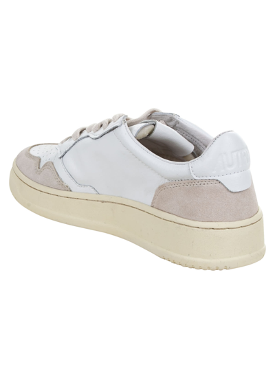 Shop Autry Logo Patched Sneakers In Leather/suede White