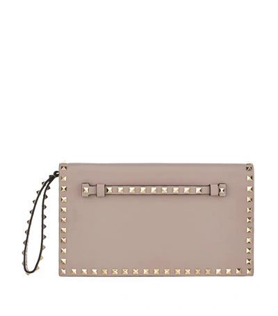 Shop Valentino Rockstud Clutch In Poudre/red