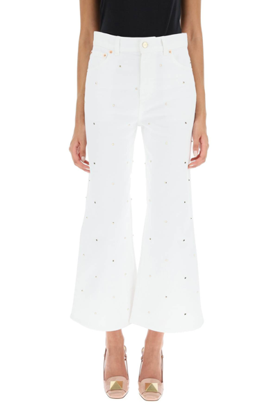 Shop Valentino Cropped Jeans With Studs In White