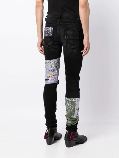 Shop Amiri Distressed Patchwork Skinny Jeans In Schwarz