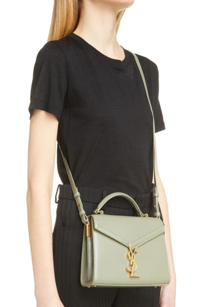 Shop Saint Laurent Mini Cassandra Leather Top Handle Bag In Light Sage