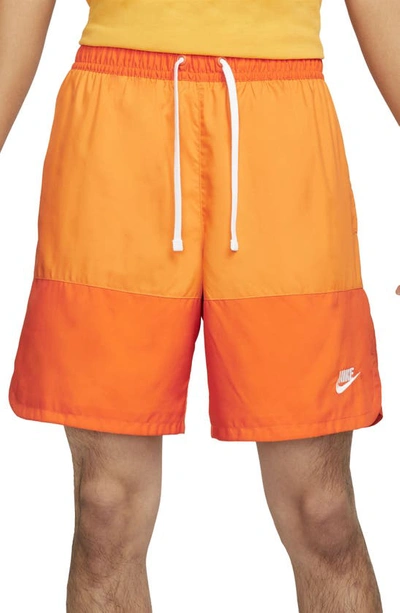 Shop Nike Essentials Colorblock Flow Shorts In Magma Orange/ Kumquat