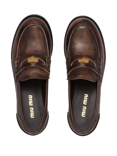Shop Miu Miu Logo-embossed Leather Penny Loafers In Braun