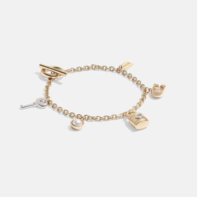 Shop Coach Outlet Signature Padlock And Key Charm Bracelet In Yellow