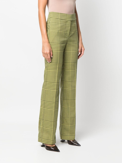 Shop Alexandre Vauthier Houndstooth-print Flared Trousers In Grün