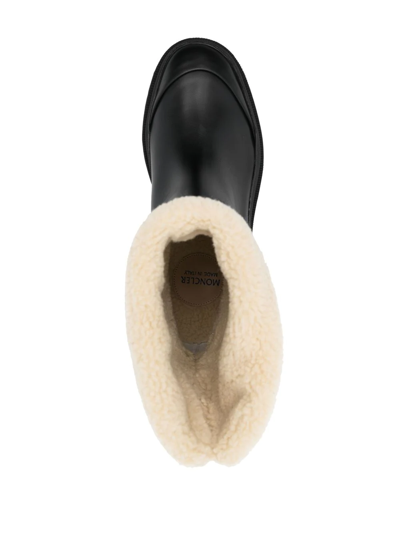 Shop Moncler Embossed-logo Ankle Boots In Schwarz