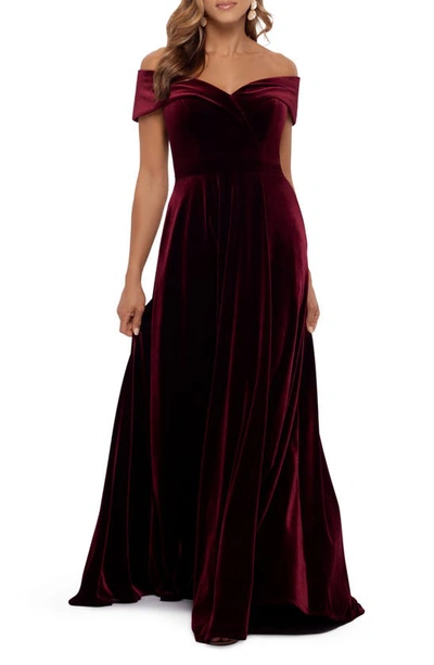Shop Xscape Off The Shoulder Velvet Gown In Burgundy