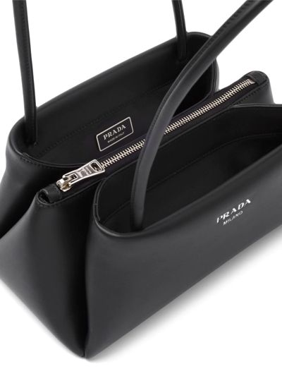 Shop Prada Small Logo-embossed Shoulder Bag In Black