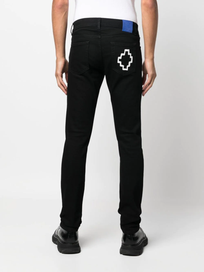 Shop Marcelo Burlon County Of Milan Tempera Cross Logo-print Slim-cut Jeans In Schwarz