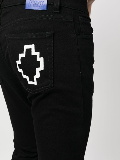 Shop Marcelo Burlon County Of Milan Tempera Cross Logo-print Slim-cut Jeans In Schwarz