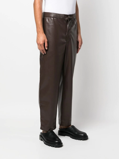 Shop Nanushka Straight-leg Leather-effect Trousers In Braun