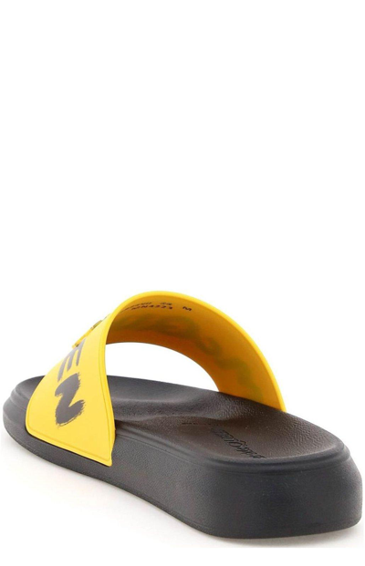 Shop Alexander Mcqueen Graffiti Logo Open Toe Slides In Giallo