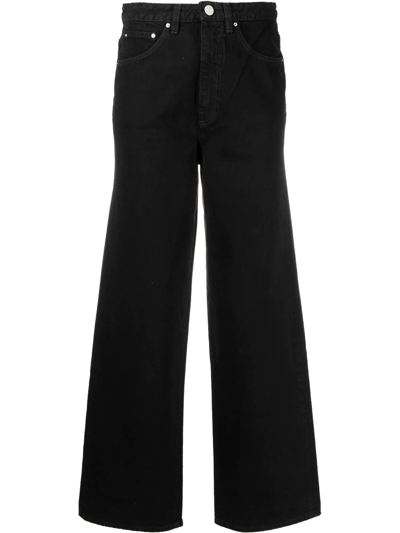 Shop Totême High-waisted Flared Jeans In Black