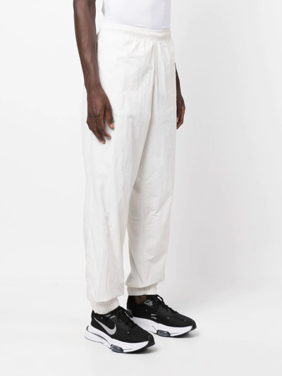 Shop Nike Solo Swoosh Track Pants In White