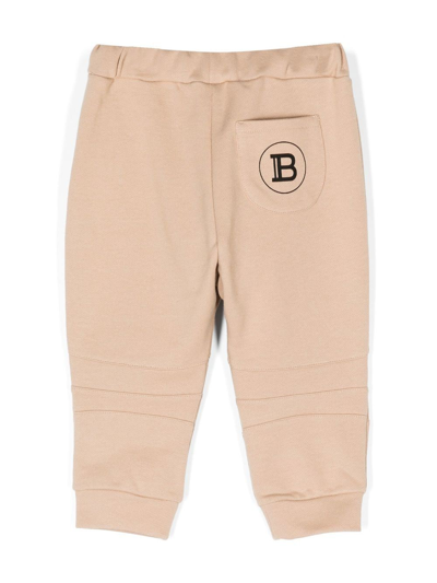 Shop Balmain Logo-print Cotton Track Pants In 褐色