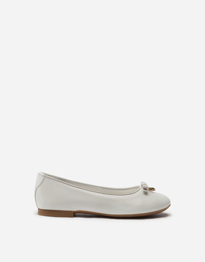 Shop Dolce & Gabbana Patent Leather Ballerina Shoe With Bow In White