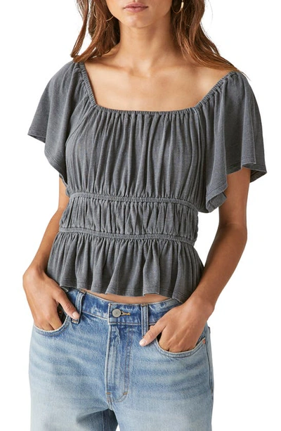 Shop Lucky Brand Lace-up Back Knit Peplum Top In Washed Black