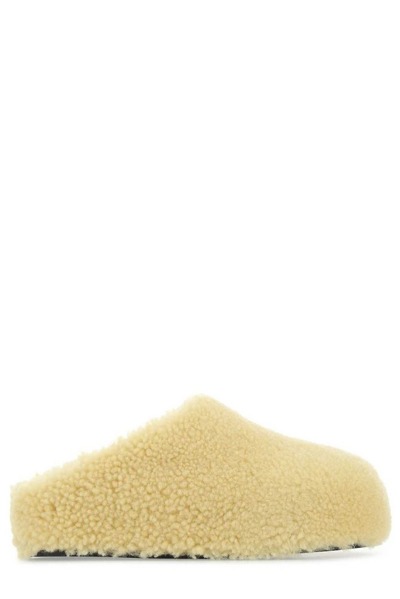 Shop Amina Muaddi Giuly Tan Shearling Round Toe Slippers In Yellow