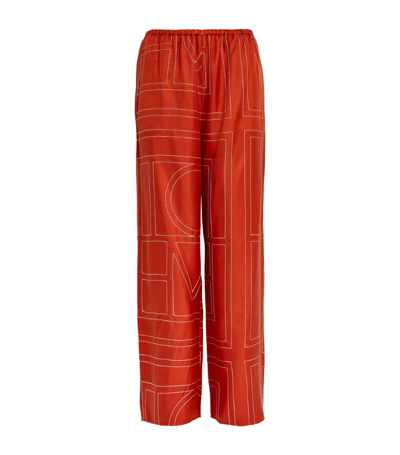Shop Totême Toteme Silk Monogram Wide-leg Trousers In Orange