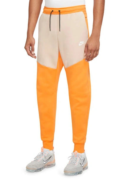 Shop Nike Tech Fleece Jogger Sweatpants In Kumquat/ Sanddrift/ White