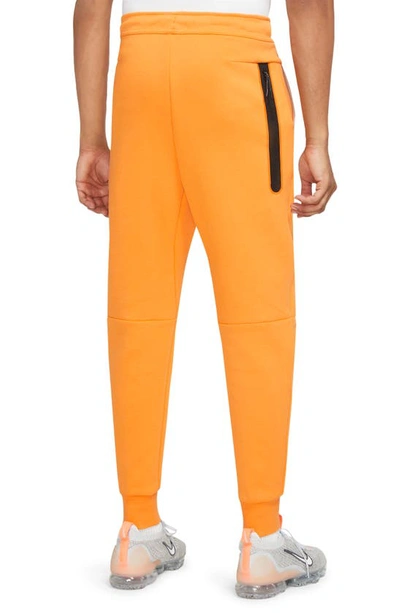 Shop Nike Tech Fleece Jogger Sweatpants In Kumquat/ Sanddrift/ White