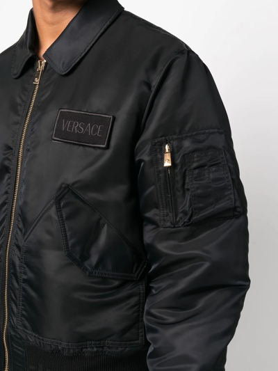 Shop Versace Logo-patch Bomber Jacket In Schwarz