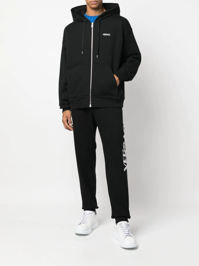 Shop Versace Logo-embroidered Track Pants In Schwarz