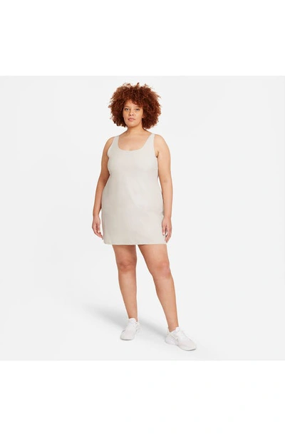 Shop Nike Bliss Lux Tank Romper Dress In Light Bone/ Clear