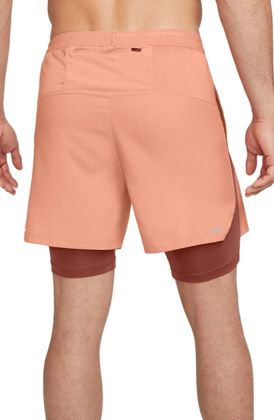 Shop Nike Dri-fit Stride Hybrid Running Shorts In Light Madder Root/ Rust/ Red