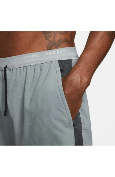 Shop Nike Dri-fit Stride Hybrid Running Shorts In Smoke Grey/ Dark Grey/ Black