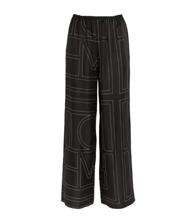 Shop Totême Toteme Silk Monogram Trousers In Black