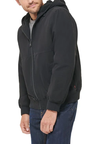 Shop Levi's Workwear Faux Shearling Lined Cotton Canvas Hooded Jacket In Black